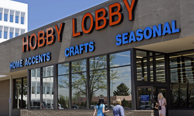 Customers enter and exit a Hobby Lobby store in Denver. The Obama administration and its opponents ...