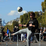 A man plays soccer on the Champs Elysees during the "day without cars", in Paris, France on Sept. 27. Pretty but noisy Paris, its gracious Old World buildings blackened by exhaust fumes, is going car-less for a day. Paris Mayor Anne Hidalgo presided over Sunday's "day without cars," two months before the city hosts the global summit on climate change. (AP Photo/Thibault Camus)
