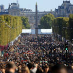 People walk on the Champs Elysees during the "day without cars", in Paris, France on Sept. 27. Pretty but noisy Paris, its gracious Old World buildings blackened by exhaust fumes, is going car-less for a day. Paris Mayor Anne Hidalgo presided over Sunday's "day without cars," two months before the city hosts the global summit on climate change. (AP Photo/Thibault Camus)