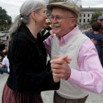 Lauri Miller and Don Morgan dance on the steps of the Capitol in Olympia, Wash., Monday, April 1, 2013. Several dozen people danced in the Washington capital to protest the tax and show support for a measure repealing it. (AP Photo/Manuel Valdes)